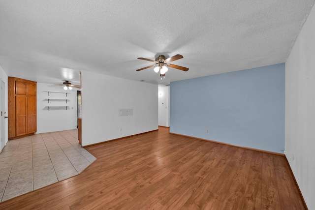 1945 Luning St, Red Bluff, CA 96080 - unfurnished room featuring ceiling fan, a textured ceiling, light wood finished floors, and baseboards