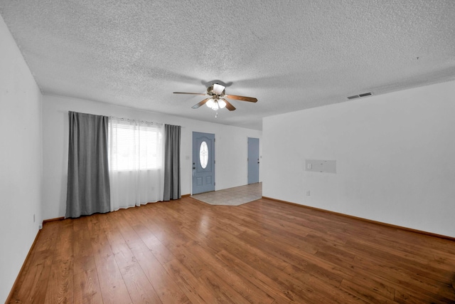 1945 Luning St, Red Bluff, CA 96080 - unfurnished room featuring ceiling fan, hardwood / wood-style floors, a textured ceiling, and baseboards