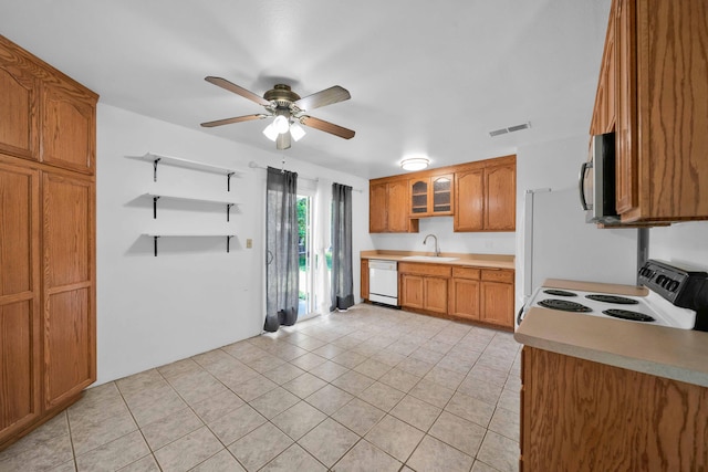 1945 Luning St, Red Bluff, CA 96080 - kitchen featuring white appliances, brown cabinets, light tile patterned floors, ceiling fan, and a sink