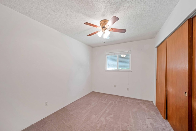 1945 Luning St, Red Bluff, CA 96080 - unfurnished bedroom featuring light carpet, a closet, a textured ceiling, and a ceiling fan
