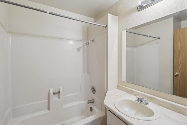 bathroom with shower / washtub combination and vanity