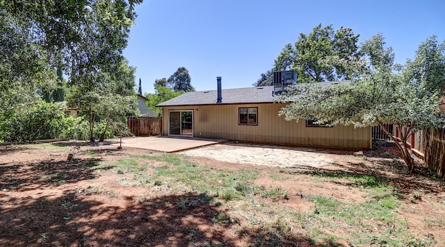 rear view of property with a patio and a fenced backyard