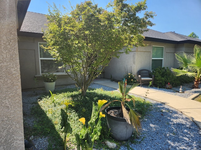 3621 Sacramento Dr, Redding, CA 96001 - view of side of property featuring stucco siding and a shingled roof