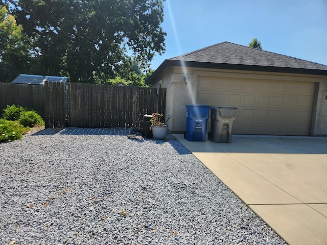 3621 Sacramento Dr, Redding, CA 96001 - view of side of home featuring a garage, stucco siding, and driveway