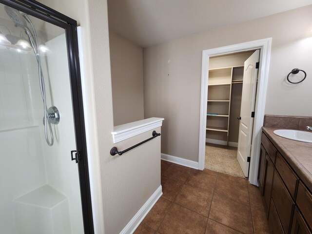3621 Sacramento Dr, Redding, CA 96001 - full bathroom with a shower stall, vanity, tile patterned floors, and a spacious closet
