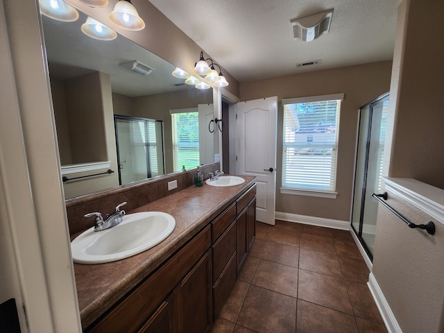 3621 Sacramento Dr, Redding, CA 96001 - full bath featuring a shower stall, double vanity, and tile patterned floors