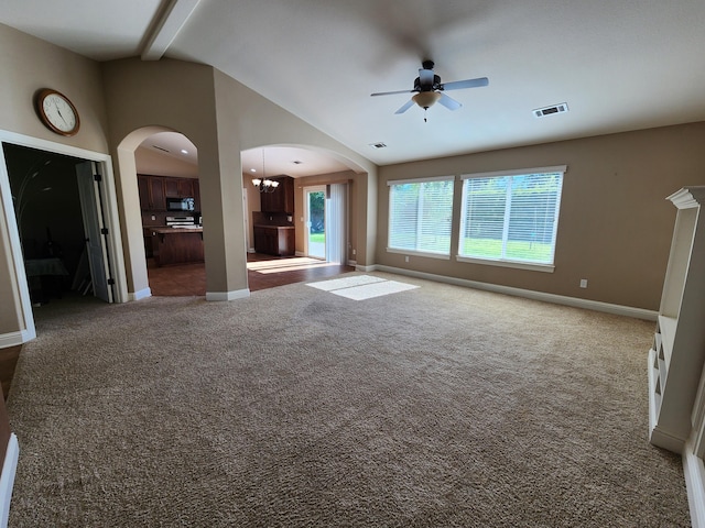 3621 Sacramento Dr, Redding, CA 96001 - unfurnished living room featuring a ceiling fan, carpet floors, arched walkways, lofted ceiling, and a chandelier