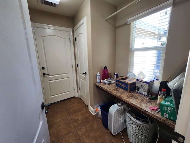 3621 Sacramento Dr, Redding, CA 96001 - laundry room with dark tile patterned floors