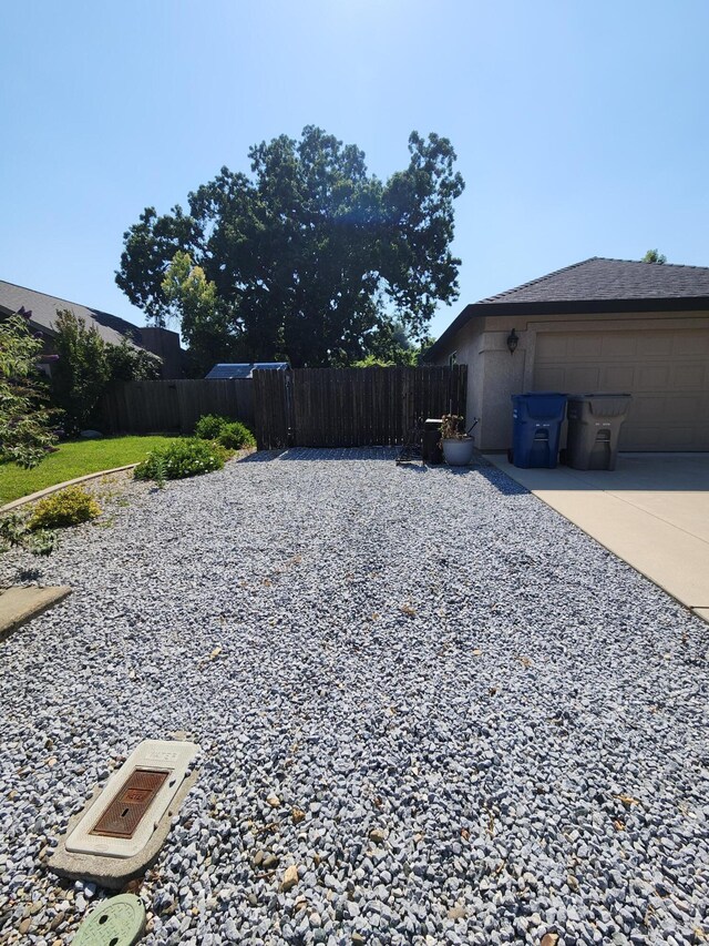 3621 Sacramento Dr, Redding, CA 96001 - view of yard with a garage and concrete driveway