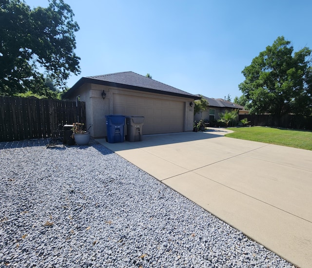 3621 Sacramento Dr, Redding, CA 96001 - view of property exterior with driveway, an attached garage, and stucco siding