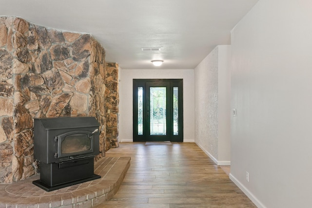 5165 Rancho Vista Way, Redding, CA 96002 - entrance foyer featuring a wood stove, wood finished floors, and baseboards