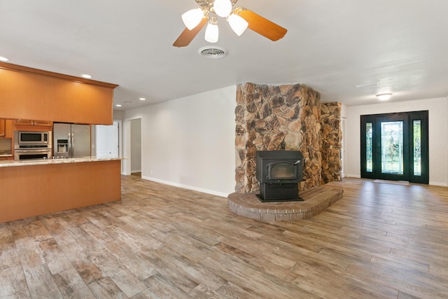 5165 Rancho Vista Way, Redding, CA 96002 - unfurnished living room with light wood-style floors, a wood stove, recessed lighting, baseboards, and ceiling fan