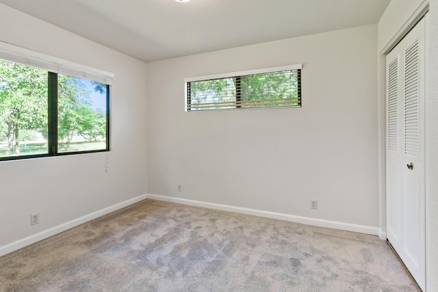5165 Rancho Vista Way, Redding, CA 96002 - unfurnished bedroom featuring multiple windows, a closet, carpet floors, and baseboards