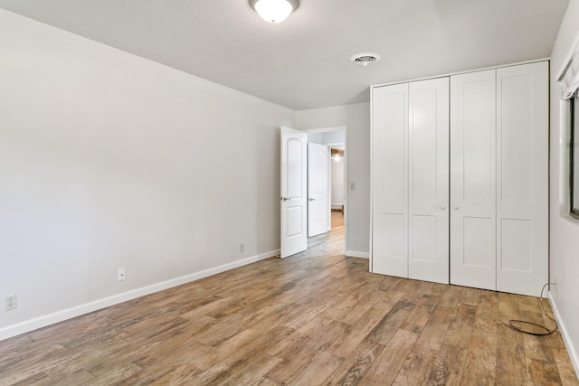 5165 Rancho Vista Way, Redding, CA 96002 - unfurnished bedroom featuring light wood finished floors, baseboards, and a closet