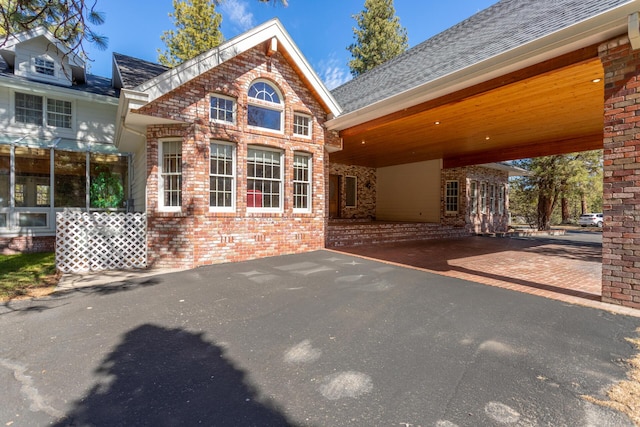 17917 Lakeshore Dr, Weed, CA 96094 - back of property with brick siding, driveway, a shingled roof, and a carport