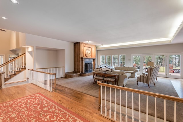 17917 Lakeshore Dr, Weed, CA 96094 - living area with light wood-type flooring, a tiled fireplace, recessed lighting, and stairway