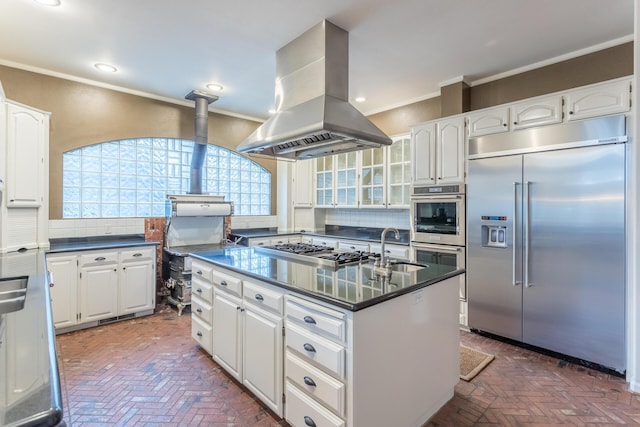 17917 Lakeshore Dr, Weed, CA 96094 - kitchen featuring stainless steel appliances, island range hood, dark countertops, brick floors, and ornamental molding