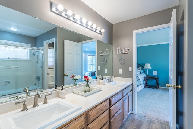 17917 Lakeshore Dr, Weed, CA 96094 - bathroom with connected bathroom, a shower with shower door, toilet, wood finished floors, and double vanity