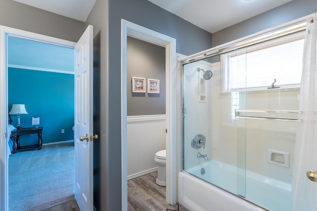 17917 Lakeshore Dr, Weed, CA 96094 - full bathroom featuring toilet, bath / shower combo with glass door, wood finished floors, and a wainscoted wall