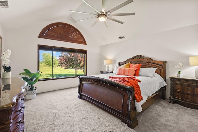 carpeted bedroom with vaulted ceiling and a ceiling fan
