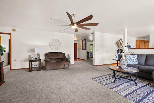 living area featuring carpet flooring, a ceiling fan, and baseboards