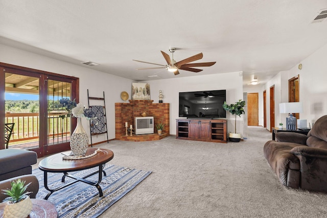 living room with ceiling fan, carpet flooring, and heating unit