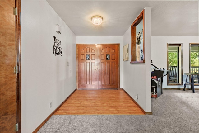 carpeted entrance foyer with baseboards
