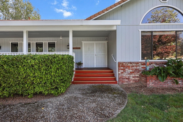entrance to property with brick siding and covered porch