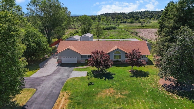 aerial view of property and surrounding area with a forest