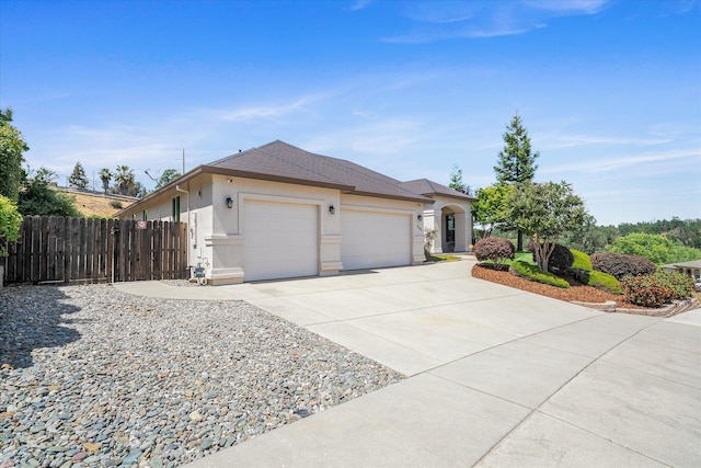 792 Bellagio, Redding, CA 96003 - view of front of property with an attached garage, fence, concrete driveway, and stucco siding