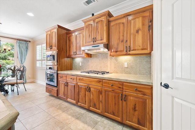 792 Bellagio, Redding, CA 96003 - kitchen featuring appliances with stainless steel finishes, light countertops, baseboards, backsplash, and under cabinet range hood
