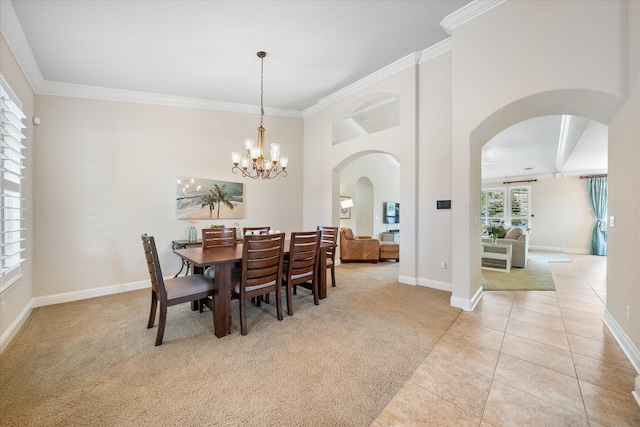 792 Bellagio, Redding, CA 96003 - dining room featuring arched walkways, light carpet, crown molding, baseboards, and a chandelier