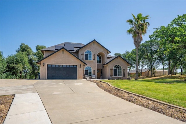 20030 Clay Ct, Cottonwood, CA 96022 - view of front facade featuring concrete driveway, a front lawn, solar panels, an attached garage, and stucco siding