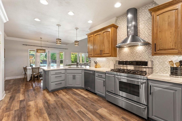 20030 Clay Ct, Cottonwood, CA 96022 - kitchen featuring appliances with stainless steel finishes, wall chimney exhaust hood, gray cabinetry, a sink, and a peninsula