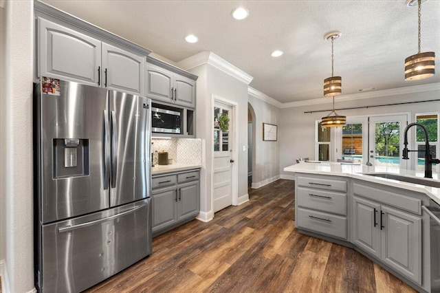 20030 Clay Ct, Cottonwood, CA 96022 - kitchen with appliances with stainless steel finishes, gray cabinets, a sink, ornamental molding, and arched walkways