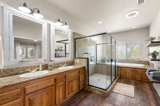 20030 Clay Ct, Cottonwood, CA 96022 - full bathroom featuring wood finished floors, a shower stall, a garden tub, and double vanity