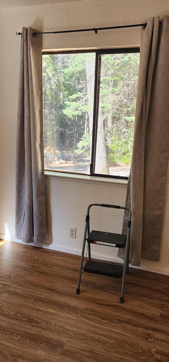 7670 Cedar Crest Rd, Shingletown, CA 96088 - sitting room with wood finished floors, plenty of natural light, a textured wall, and baseboards