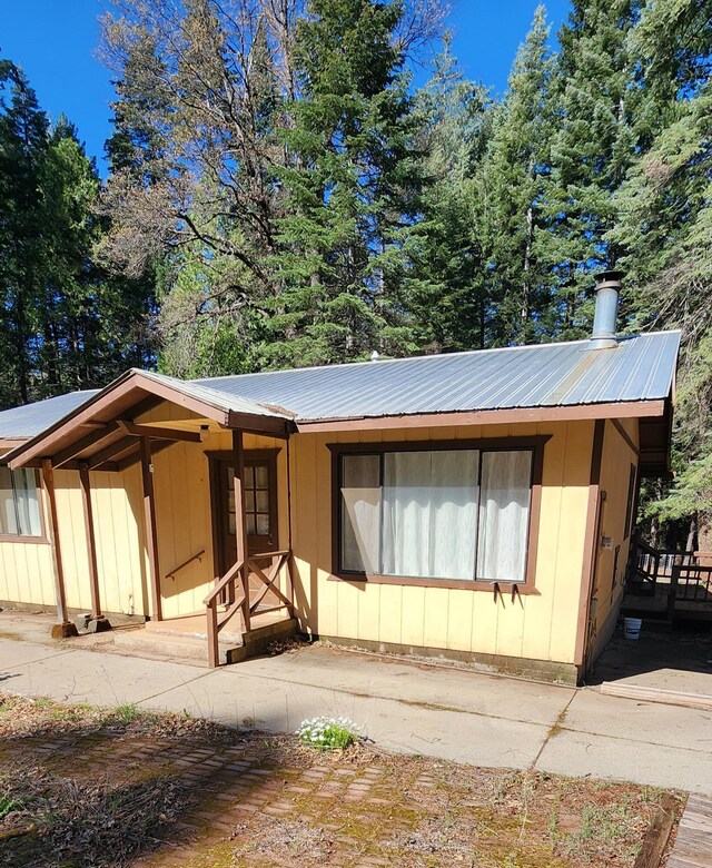 7670 Cedar Crest Rd, Shingletown, CA 96088 - view of front of house featuring metal roof and a chimney