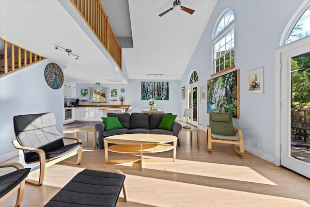 12876 E Fork Rd, French Gulch, CA 96033 - living area featuring high vaulted ceiling, wood finished floors, a ceiling fan, rail lighting, and baseboards