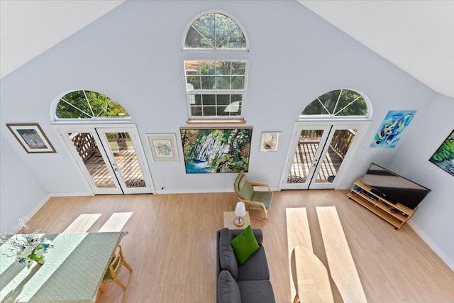 12876 E Fork Rd, French Gulch, CA 96033 - living room featuring french doors, high vaulted ceiling, wood finished floors, and baseboards