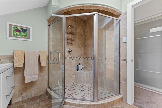 12876 E Fork Rd, French Gulch, CA 96033 - full bathroom with a stall shower, tile walls, vanity, and lofted ceiling