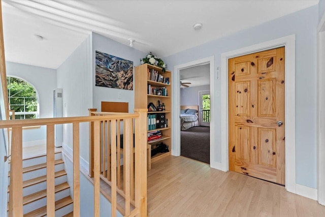 12876 E Fork Rd, French Gulch, CA 96033 - corridor featuring plenty of natural light, wood finished floors, and an upstairs landing