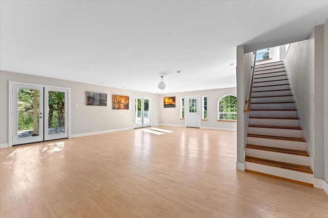 12876 E Fork Rd, French Gulch, CA 96033 - unfurnished living room featuring healthy amount of natural light, stairway, and light wood-style floors