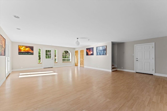 12876 E Fork Rd, French Gulch, CA 96033 - unfurnished living room with baseboards, light wood-type flooring, and stairway