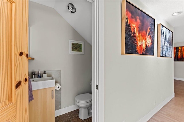 12876 E Fork Rd, French Gulch, CA 96033 - bathroom with toilet, baseboards, vanity, and lofted ceiling