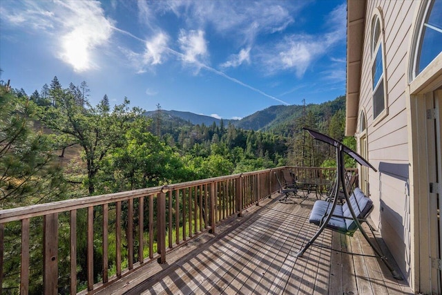 12876 E Fork Rd, French Gulch, CA 96033 - deck featuring a wooded view and a mountain view