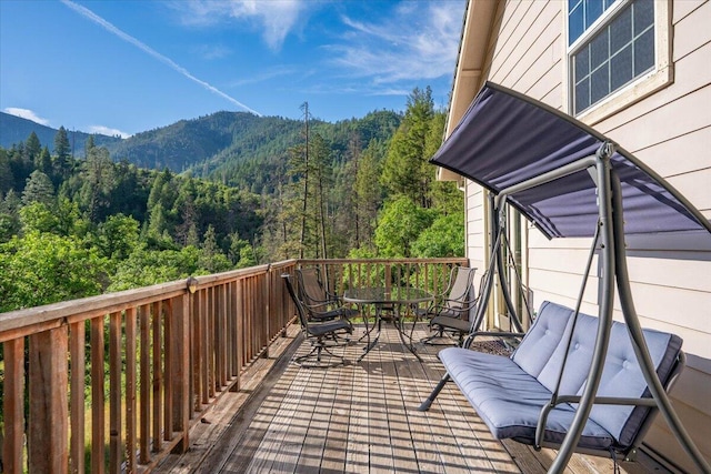 12876 E Fork Rd, French Gulch, CA 96033 - balcony with a wooded view, outdoor dining area, and a deck with mountain view