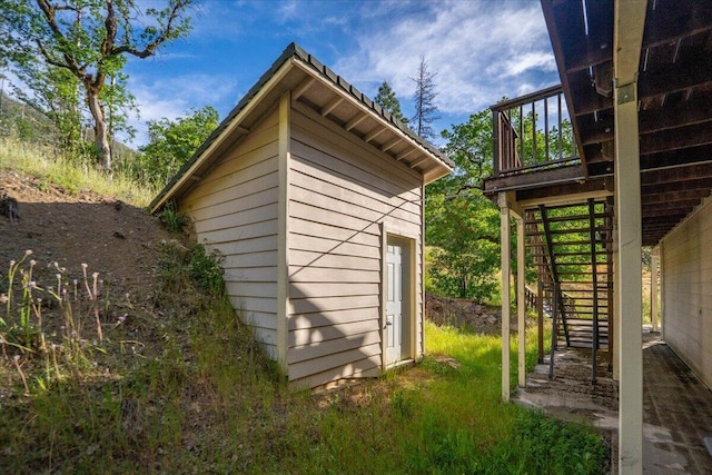 12876 E Fork Rd, French Gulch, CA 96033 - view of home's exterior featuring stairway, an outbuilding, and a wooden deck