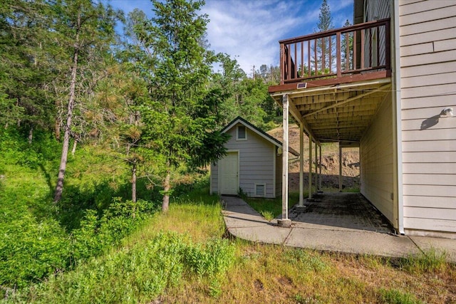 12876 E Fork Rd, French Gulch, CA 96033 - view of yard featuring an outbuilding, a wooden deck, and a storage shed