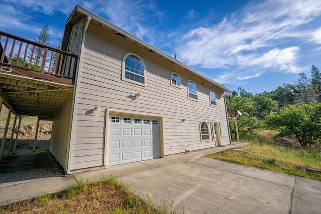 12876 E Fork Rd, French Gulch, CA 96033 - view of side of home featuring a garage, concrete driveway, and a wooden deck